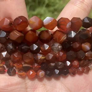 Macro view of multi-faceted red agate beads showing detailed diamond-cut surfaces
