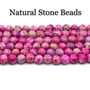 Close-up macro showing texture of magenta imperial jasper round beads for DIY jewelry