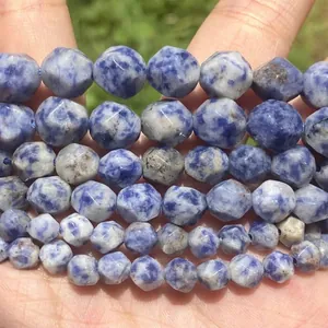 Macro detail of faceted natural blue and white stone beads with unique marble texture