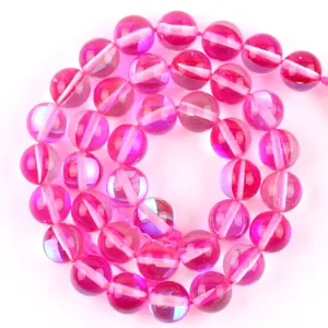 Close-up of rose red translucent round glass beads in a spiral arrangement