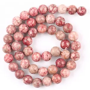 Detailed macro view of rose red natural stone chalcedony beads for DIY jewelry making.