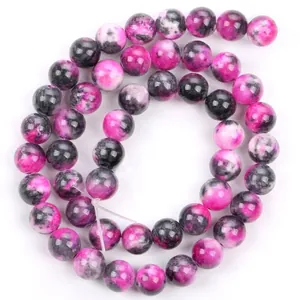 Macro detail of rose pink and black marbled natural stone beads for jewelry making