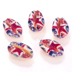 Macro detail of natural cowrie shell beads with colorful starfish patterns for DIY jewelry.