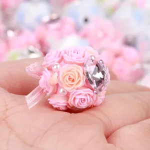 Close-up of pink rose flower ball bead with heart-shaped rhinestone and pearls