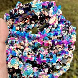 Close-up of colorful camouflage turquoise beads in various ocean and star shapes