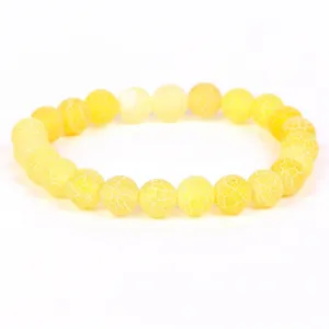 Close-up of a yellow weathered agate bracelet with unique white dragon vein patterns.