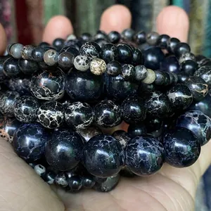 Close-up of assorted natural black Imperial Jasper stone beads in various sizes