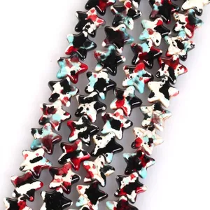 Close-up of star-shaped turquoise beads with colorful camouflage pattern for DIY jewelry
