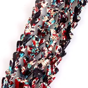 Close-up detail of vibrant camouflage butterfly-shaped turquoise beads for DIY crafts