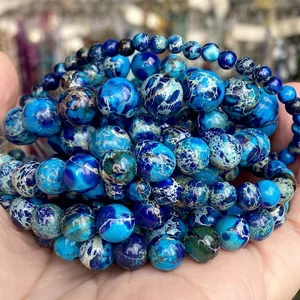 Macro view of blue natural imperial jasper round beads showing marble textures and sizes