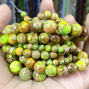 Detailed macro shot of natural green and yellow imperial stone round beads for DIY jewelry