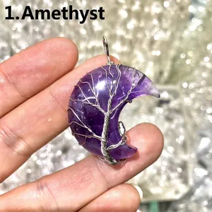 Close-up detail of a moon-shaped amethyst pendant with silver wire-wrapped tree of life design.