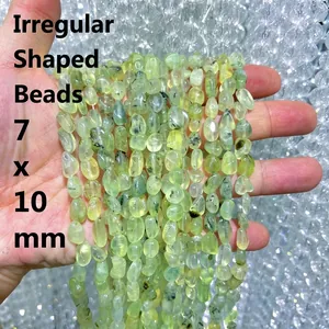 Detailed macro view of irregular light green prehnite tumbled stone beads, size 7x10mm