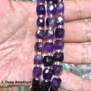 Close-up view of natural dark amethyst faceted cube beads used for DIY jewelry making