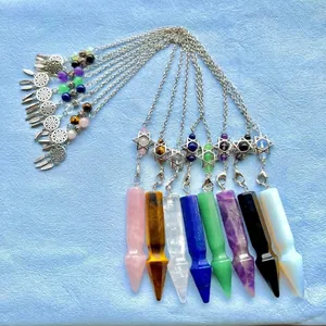 Close-up of hexagonal crystal pendulums with hexagram charms in diverse natural stones