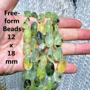 Macro detail of natural freeform prehnite beads showing unique black inclusions