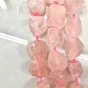 Detail showing irregular natural rose quartz raw stone beads on pink string