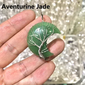 Detail of green aventurine moon pendant with silver wire-wrapped tree of life