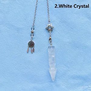 Detailed view of a clear quartz crystal pendulum with star and dreamcatcher charms.