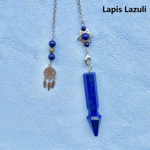 Detailed view of a blue lapis lazuli crystal pendulum with a star and dreamcatcher charm.