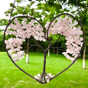 Close-up of a handmade wire wrapped heart life tree ornament with pink rose quartz chips