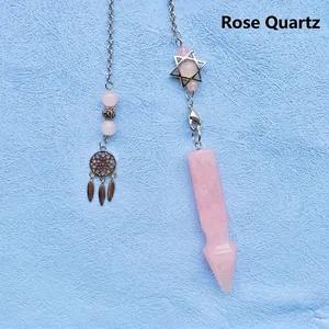 Detail view of rose quartz dowsing pendulum with Star of David and dreamcatcher charms