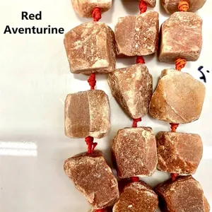 Close-up of irregular natural Red Aventurine raw stone beads for DIY jewelry making