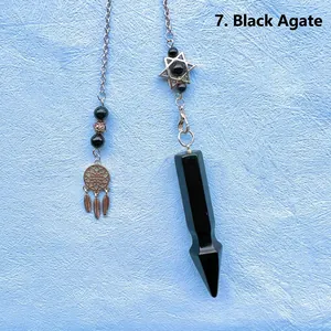 Close-up of black agate crystal pendulum with hexagram and dreamcatcher charms