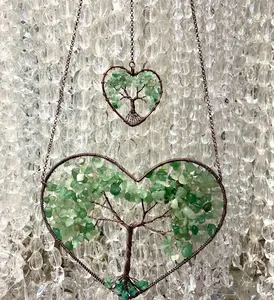 Macro detail of handmade heart-shaped tree of life wall hanging with green aventurine