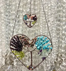 Intricate detail of wire-wrapped heart Tree of Life pendants with vibrant natural crystals
