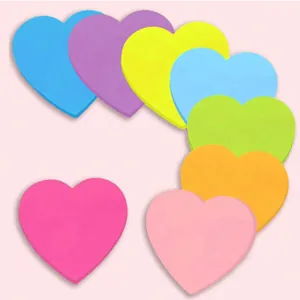Detailed view of colorful heart-shaped neon sticky notes in multiple vibrant colors.