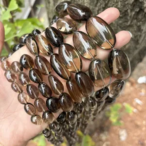Close-up macro view of translucent natural smoky quartz irregular tumbled beads for DIY jewelry