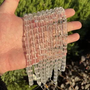 Close-up of natural Brazil clear quartz cylindrical beads for DIY handmade jewelry crafts