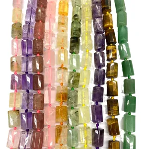 Detail view of 12x16mm natural cylindrical crystal beads in various colorful stones.