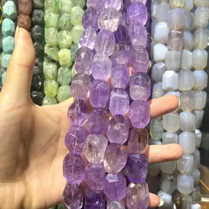 Close-up of faceted natural purple amethyst crystal beads for DIY jewelry making crafts