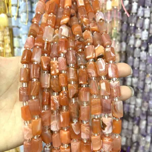 Close-up detail of 8x12mm faceted natural orange agate cylinder beads for DIY jewelry