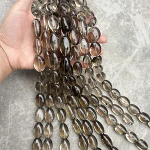 Close-up of natural smoky quartz oval beads for DIY jewelry necklace making.