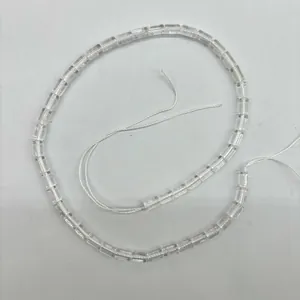 Macro detail view of natural clear quartz cylindrical beads for DIY jewelry making