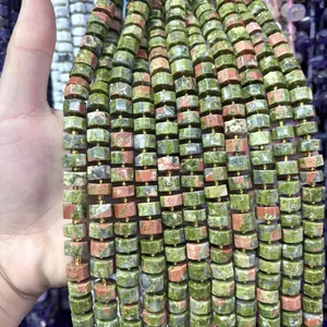 Close-up of 6x10mm faceted green and pink Unakite stone beads for jewelry DIY.