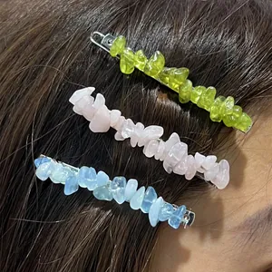 Detail view of irregular natural crushed stone hairpins in green, pink, and blue colors