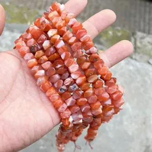 Detailed close-up of faceted natural red agate stone beads for DIY jewelry and bracelets