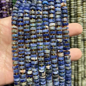 Macro view showing the texture of 4x8mm blue faceted natural stone spacer beads.