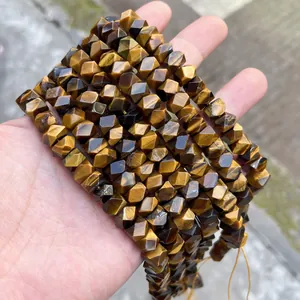 Close-up of faceted natural Tiger's Eye stone beads for handmade DIY jewelry making projects.