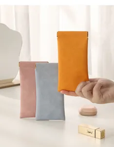 Portable soft squeeze top sunglasses storage pouches in orange, pink, and blue.