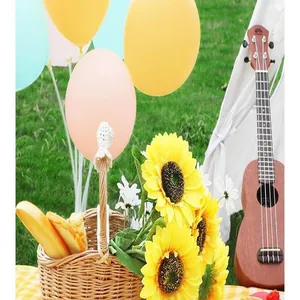Yellow plaid waterproof picnic mat in a cozy outdoor camping scene with sunflowers and tent