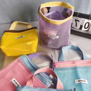 Detailed macro view of colorful mesh storage bags featuring durable zippers and handles
