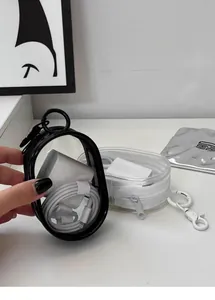 Detailed view of a transparent portable organizer case storing a white charger and cable