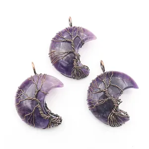 Detailed view of crescent moon amethyst pendants featuring handmade Tree of Life copper wire wrap