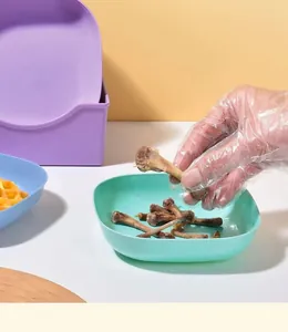 Detail view of light green plastic bone spit dish showing practical usage for food waste