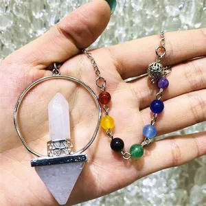 Detailed macro view of a rose quartz hexagonal pillar pendulum with seven colorful chakra beads